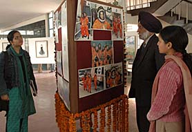 Visitors look at the photographs, paintings and posters of Kalpana Chawla at a function organised by the Kalpana Chawla Memorial Foundation at Punjab Engineering College, Chandigarh