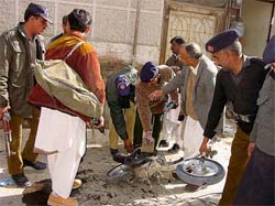 Pakistani officials examine the site of a bomb blast in Quetta on Tuesday. At least one man was killed and six were wounded when three blasts rocked Quetta. 