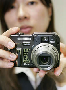 Japans Casio Computer employee Reiko Matsubara displays the new digital camera