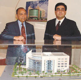 Noida Entertainment Centre Chairman Mahesh Prasad and CEO Aditya Sikri with a model of the centre, which will be open in June 2005, at a press conference in the Capital on Wednesday. 