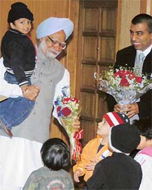 Prime Minister Manmohan Singh with children of Star ABC Nursery School while receiving the cheques for the Prime Ministers National Relief Fund for tsunami victims, collected by the school students at the Prime Ministers residence in New Delhi on Wednesday. 