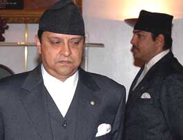 King Gyanendra pauses next to Prince Paras, as he swears in a 10-member Cabinet heavily dominated by his own supporters on Wednesday.