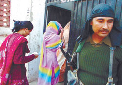 A securityman keeping vigil at Jhjharsa village polling station in Gurgaon on Thursday. 