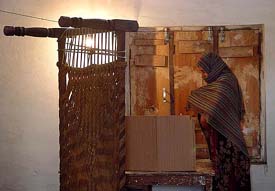 An apology for a polling booth: A Muslim woman exercises her franchise at the Mundi Garhi polling station in the Gharaunda constituency of Karnal district on Thursday