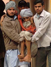 Sant Singh(97) of Kot village in the Kalka constituency is being carried by his great-grandsons to a polling booth on Thursday