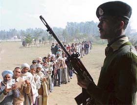 A paramilitary force personnel stands guard at a hypersensitive polling station in Ambala 