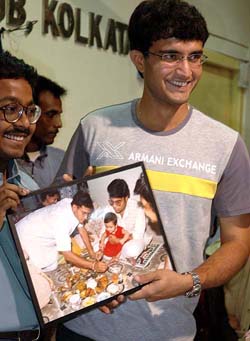 Indian captain Sourav Ganguly shows a photograph after releasing Anya Sourav