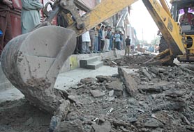 Encroachments being removed in Sector 35 in Chandigarh on Friday. 