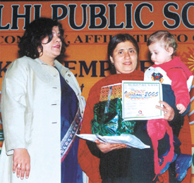 A baby receiving first prize in the Photogenic Baby category 