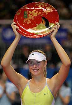 Russian Maria Sharapova shows off her trophy