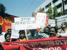 CPI and CPM workers protest in front of the BSNL head office in Bhubaneswar on Monday against the hike of FDI cap in the telecom sector by the UPA goverment. 