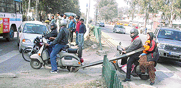 On the Chandigarh-Ambala road people use a gap in the railing for crossing to other side unmindful of the danger.