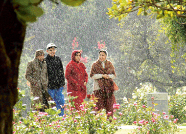These visitors at the Rose Garden seem to enjoy light showers in Chandigarh on Monday.