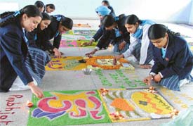 Students draw colourful rangolis at a competition organised at Guru Nanak Public School in Ludhiana on Monday