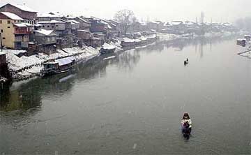 A view of snow covered house-boats and houses in Srinagar