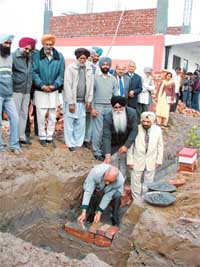 Mr Hoshiar Singh Grewal, an NRI, lays the foundation stone of the girls hostel at the Kartar Singh Sarabha Memorial Ayurvedic College and Hospital, Sarabha, on Tuesday.