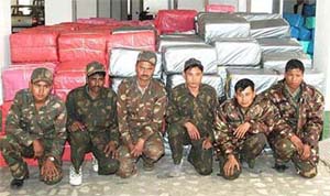 Six men dressed as BSF constables, who were escorting the two trucks carrying 9,733 kg of ganja (cannabis) worth nearly 2.5 crore rupees, sit in front of the catch