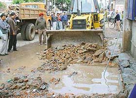 An encroachment in Sector 22 market being removed by the Municipal Corporation staff in Chandigarh