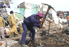 Railway employees repairing the track where a goods train came off the track at Jhuggi Basti Wazirpur industrial area in the Capital on Wednesday