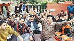 BJP activists at a dharna held outside the residence of Dr Jaswant Singh, Joint Commissioner of the MC, Ludhiana, on Wednesday. 