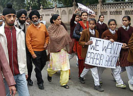 The parents, Mr K.S. Dimpi and his wife, along with other members of the family, participate in a peace march held by schoolchildren in Amritsar on Thursday.