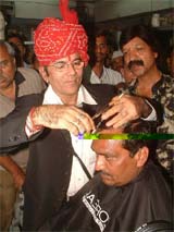 Hairdresser Jai Narain Bhatti seen performing his 1,800th haircut on Bhopal Mayor Sunil Sood
