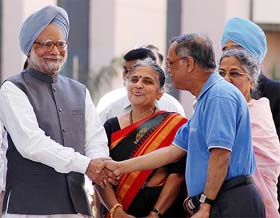 Prime Minister Manmohan Singh shakes hands with Infosys Chairman and mentor Narayan Murthy at the inauguration of the Global Education Centre at Mysore, 140 km from Bangalore