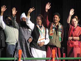 Congress President Sonia Gandhi along with party candidates waves out to supporters during an election rally