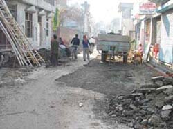 Residents of Prem Nagar Ludhiana, protest against the repair of a good road on Saturday. 