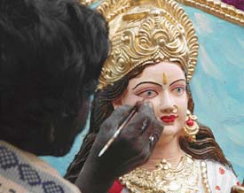 An artisan gives finishing touches to an idol of Goddess Saraswati on the eve of Basant Panchami in Ludhiana on Saturday.