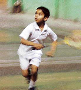 Surya Goyal (u-10 years) in action during the Ludhiana District Badminton Championship at Shatri Hall on Saturday. 