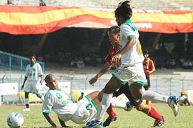 East Bengal striker Baichung Bhutia trying to get past the two Salgaokar defenders