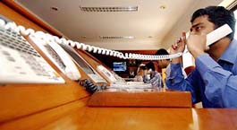 A stock broker gestures as he takes a telephone call during a hectic trading session at a brokerage firm in Mumbai on Monday, as Indian shares hit a record high.