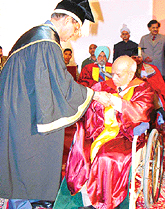 Panjab University Vice-Chancellor K.N. Pathak awards a degree of D.Litt in Arts to Mr Ram Sharma at the 54th annual convocation of the university in Chandigarh on Monday.