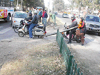 Motorists pass through a gap in the railing on the Chandigarh-Ambala highway 