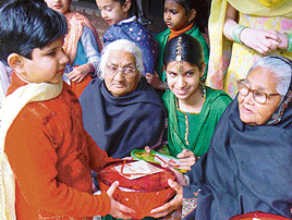 Students of Saupins School hand over gifts to inmates of the Old Age Home, Sector 15, Chandigarh, on Monday.