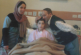 Adnan with his mother and father, Manzoor Ahmed, at his bedside.