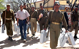 Police officials deployed on election duty carry EVMs to polling booths in Ranchi for the second phase of polling for 29 Assembly seats of Jharkhand 