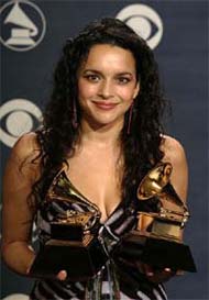 Norah Jones poses backstage with her two awards at the 47th Annual Grammy Awards at the Staples Center in Los Angeles