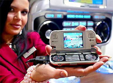 A representative from LG Electronics shows the companys new SV 360 Game Phone, which also acts as an mp3 player, during the 3GSM World Congress 2005 in Cannes