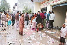 A crowd outside Sri Ganesh Home Appliances in Haripur village, Panchkula, after the shop was looted by a mob