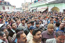 Grieving residents gather outside the house of Abhi Verma on Tuesday after his body was found from fields near Adampur.