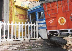 A truck that rammed into a crash barrier near Dholewal chowk in Ludhiana on Wednesday.