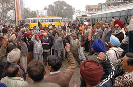Members of the Punjab Roadways Joint Action Committee protest against plying of private buses without valid permits at Jalandhar on Wednesday.