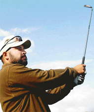 Jasjeet Singh watches his approach shot on second day of the Royal Challenge Samarvir Sahi IGU Amateur Golf Championship at Chandigarh Golf Club on Wednesday. 