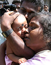Relatives of Baby Abilash or Baby 81 greet him in Kalmunai, Sri Lanka, on Wednesday