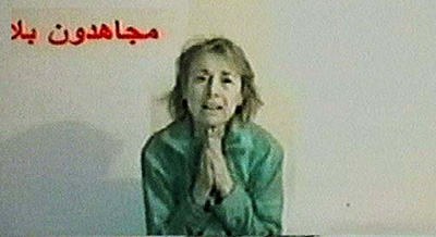 In this image taken from a video released by insurgents, a woman, who identified herself as kidnapped Italian journalist Giuliana Sgrena, pleads for her life and calling on US-led troops to pull out of Iraq