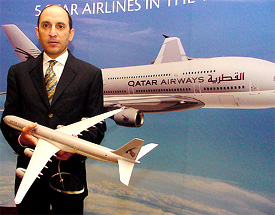 Qatar Airways CEO Akbar Al Baker holds a model of a Qatar Airways super-jumbo during a press conference in New Delhi. Qatar Airways is looking at operating passenger services to two new Indian destinations whenever a bilateral agreement between two nations is reviewed. The carrier presently operates 19 regular flights from four Indian cities to Doha in New Delhi on Thursday. Tribune photo: Mukesh Aggarwal