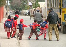 A policeman escort schoolchildren to their school on Tuesday as panic spread in Bathinda town after a bid was made to kidnap a local student on Wednesday night.