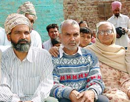 Balwinder Singh (centre) along with his mother and brother at his home in Kaniawali village.
